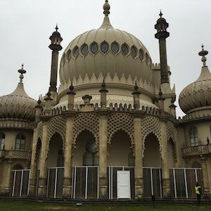 Brighton Pavilion, a beige and white Indian-style palace against a cloudy sky.