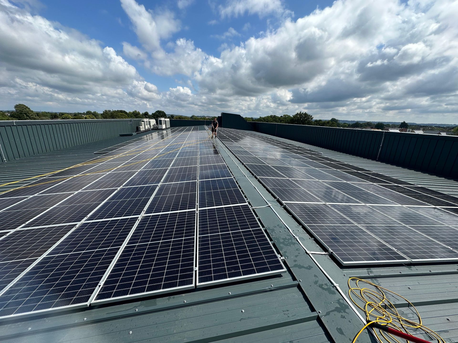 Picture of a commercial property with a lot of solar panels on the roof