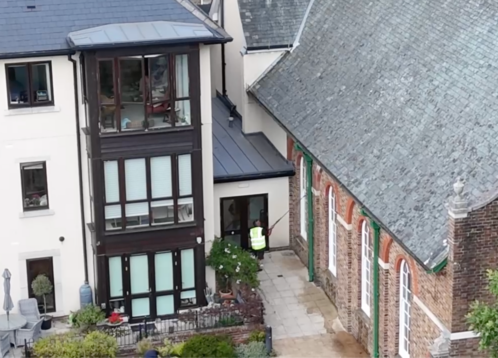 Man using telescopic pole with pure water residential window cleaning in croydon area