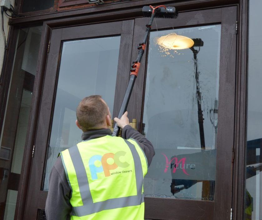 Professional window cleaning for a commercial building, showcasing streak-free glass and a polished exterior.