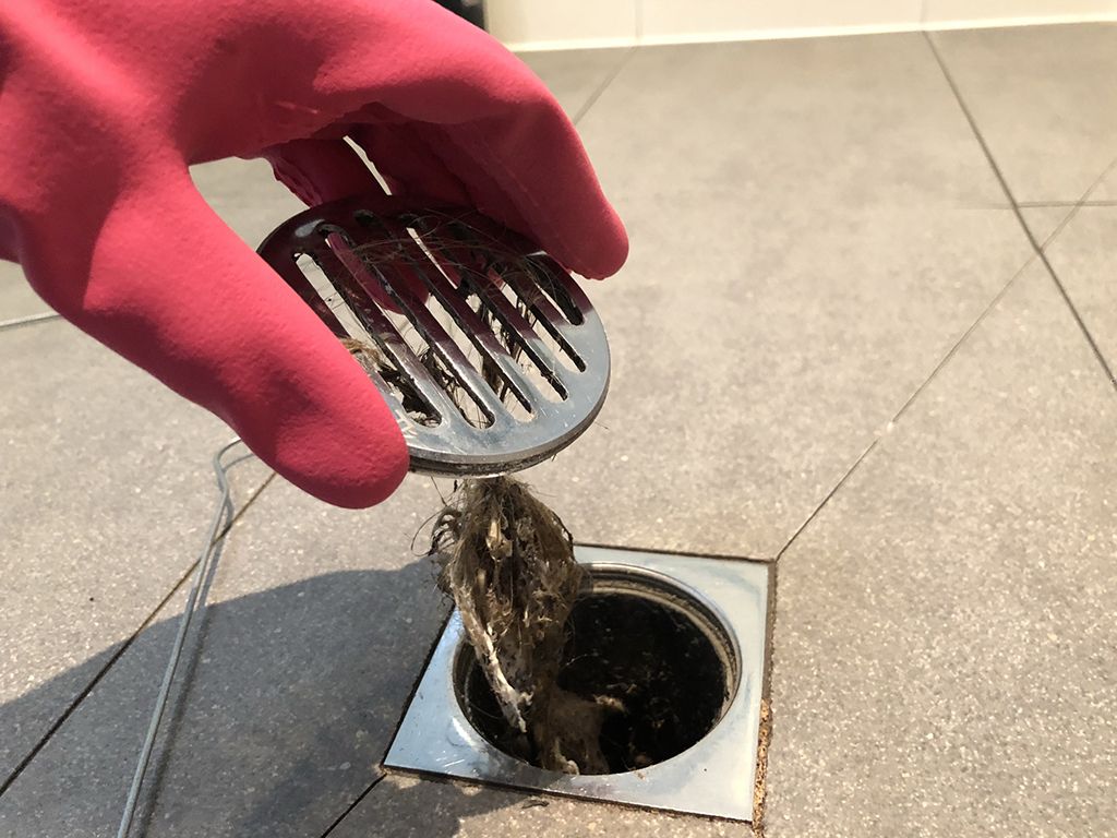 Plumber cleaning drain