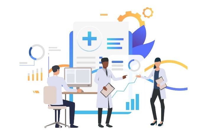 Three medical professionals reviewing data at a computer and graphs.