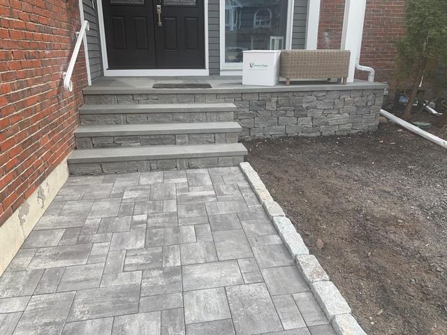 A stone walkway leading to the front door of a house.