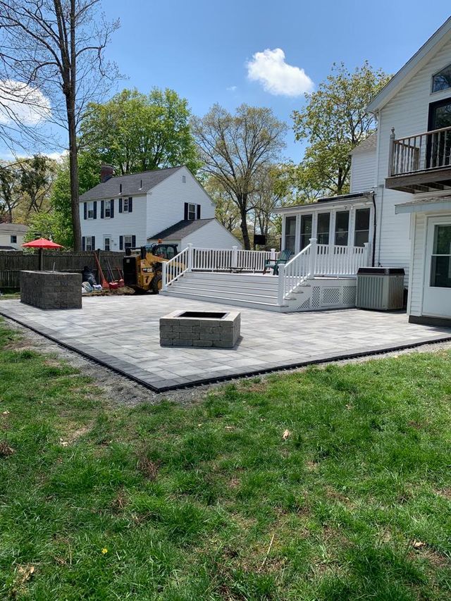 There is a fire pit in the backyard of a house.