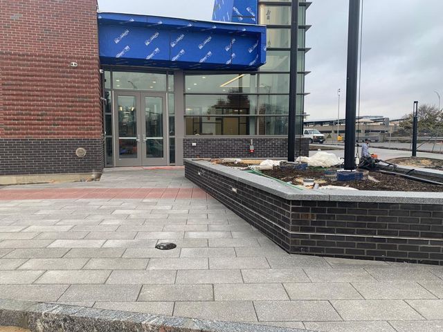 A brick building with a blue awning on top of it