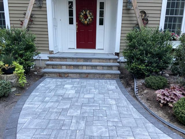 There is a walkway leading to the front door of a house.