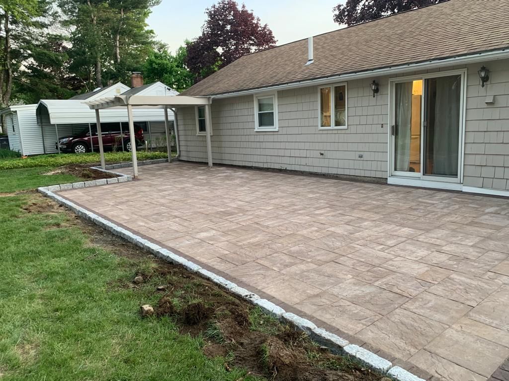 A house with a large patio in front of it.