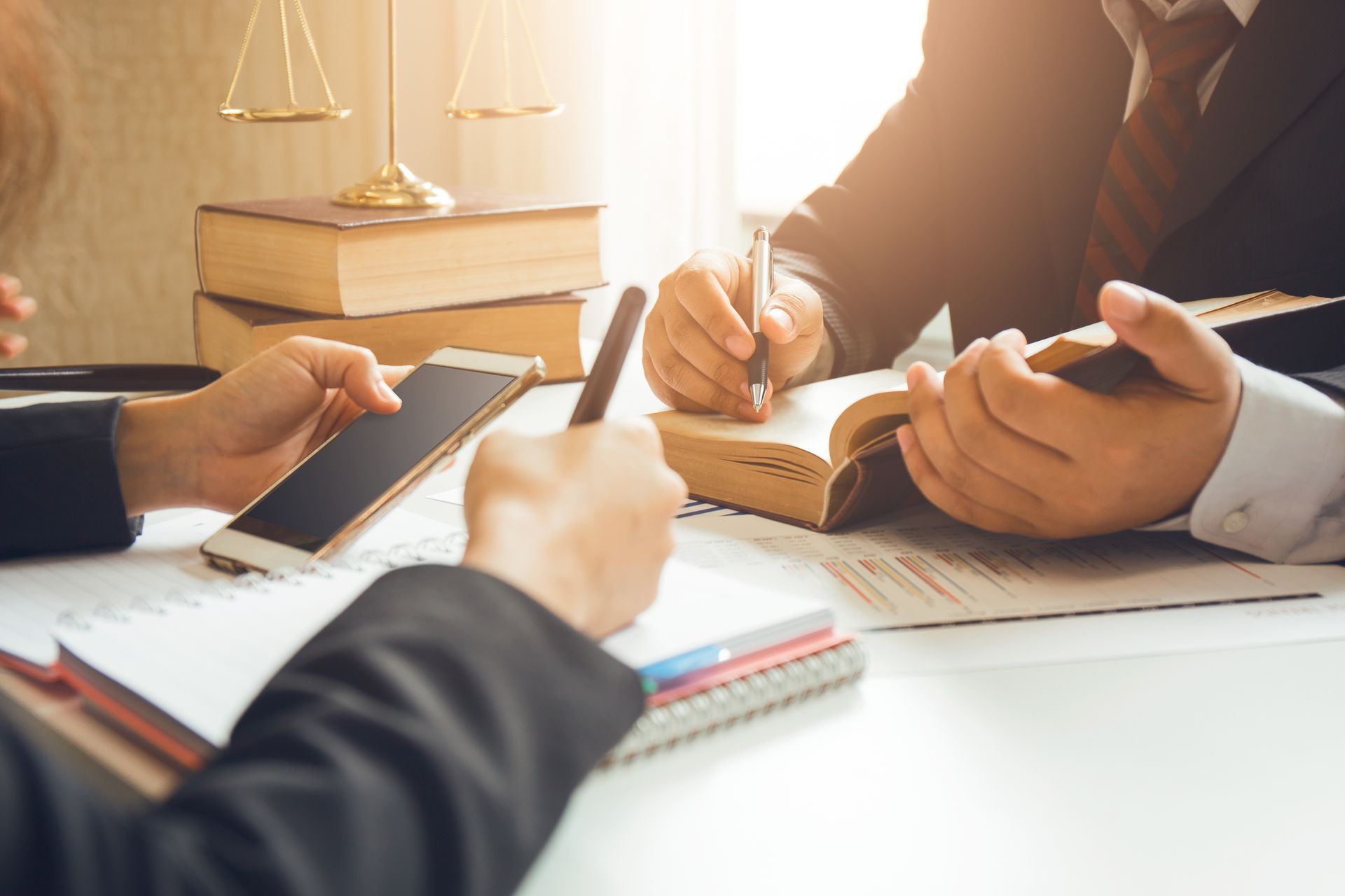 a wooden house is sitting on a wooden table next to a wooden gavel .