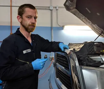 Technician performing radiator repair at ABC Auto Repair shop