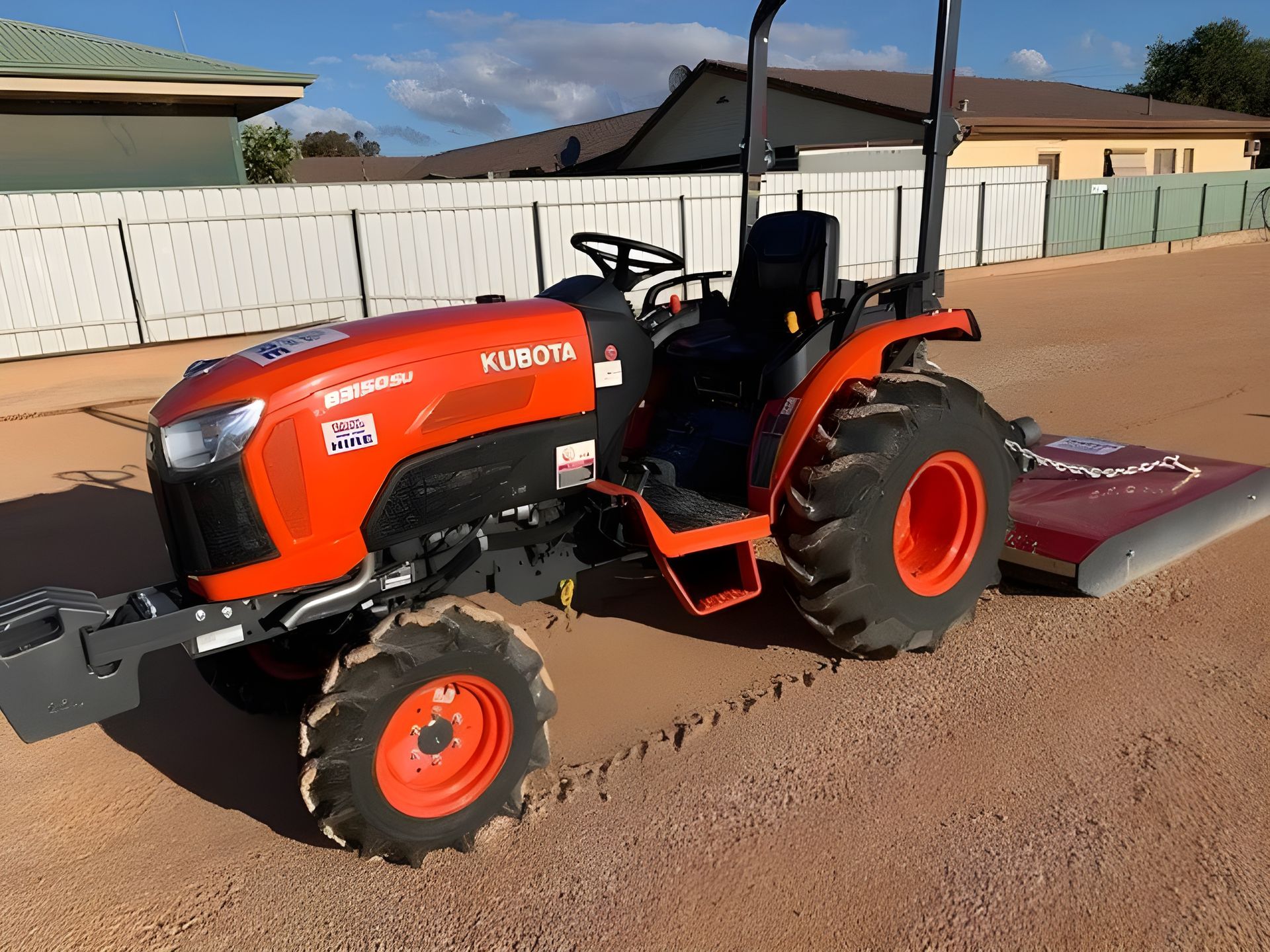 Tractor with a slasher and bucket— J & G Services in Bungadoo, QLD