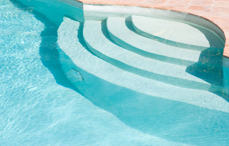 A swimming pool with stairs leading up to it