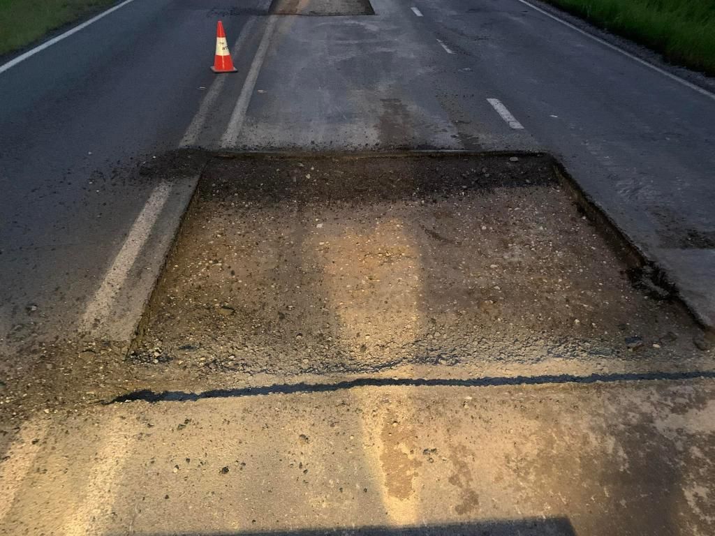 Large Hole in the Middle of a Road Next to a Traffic Cone — JP Civilworx Pty Ltd in Singleton, NSW