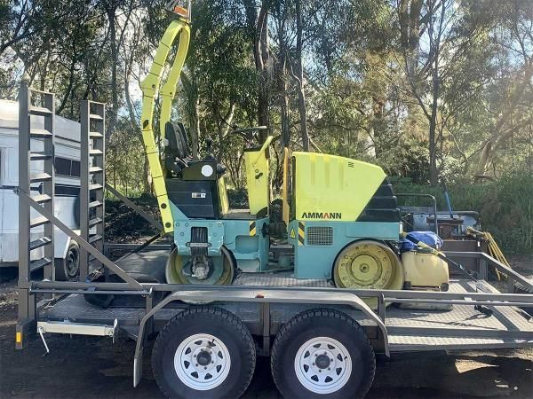 Yellow and Blue Machine is Parked on a Trailer — JP Civilworx Pty Ltd in Port Stephens, NSW