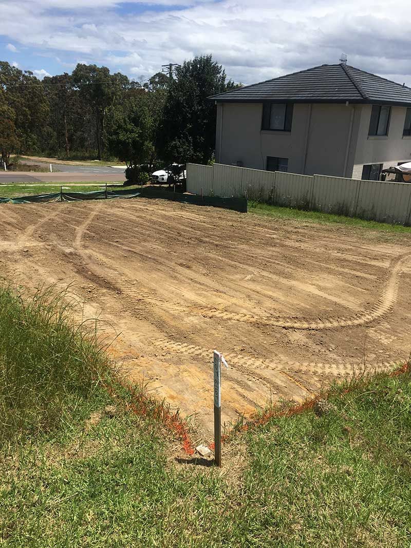 Dirt Field With a Fence and a House — JP Civilworx Pty Ltd in Taree, NSW