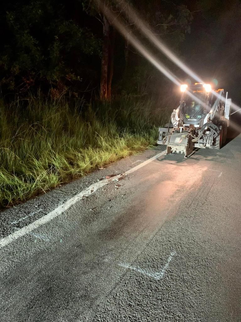 Tractor is Driving Down a Road at Night — JP Civilworx Pty Ltd in Cessnock, NSW