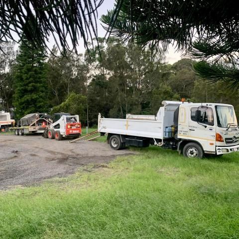 Dump Truck is Parked in a Grassy Field Next to a Bulldozer — JP Civilworx Pty Ltd in Eraring, NSW