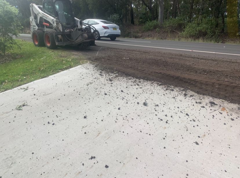 A Construction Vehicle Next To a Road And Gravel — JP Civilworx Pty Ltd in Eraring, NSW