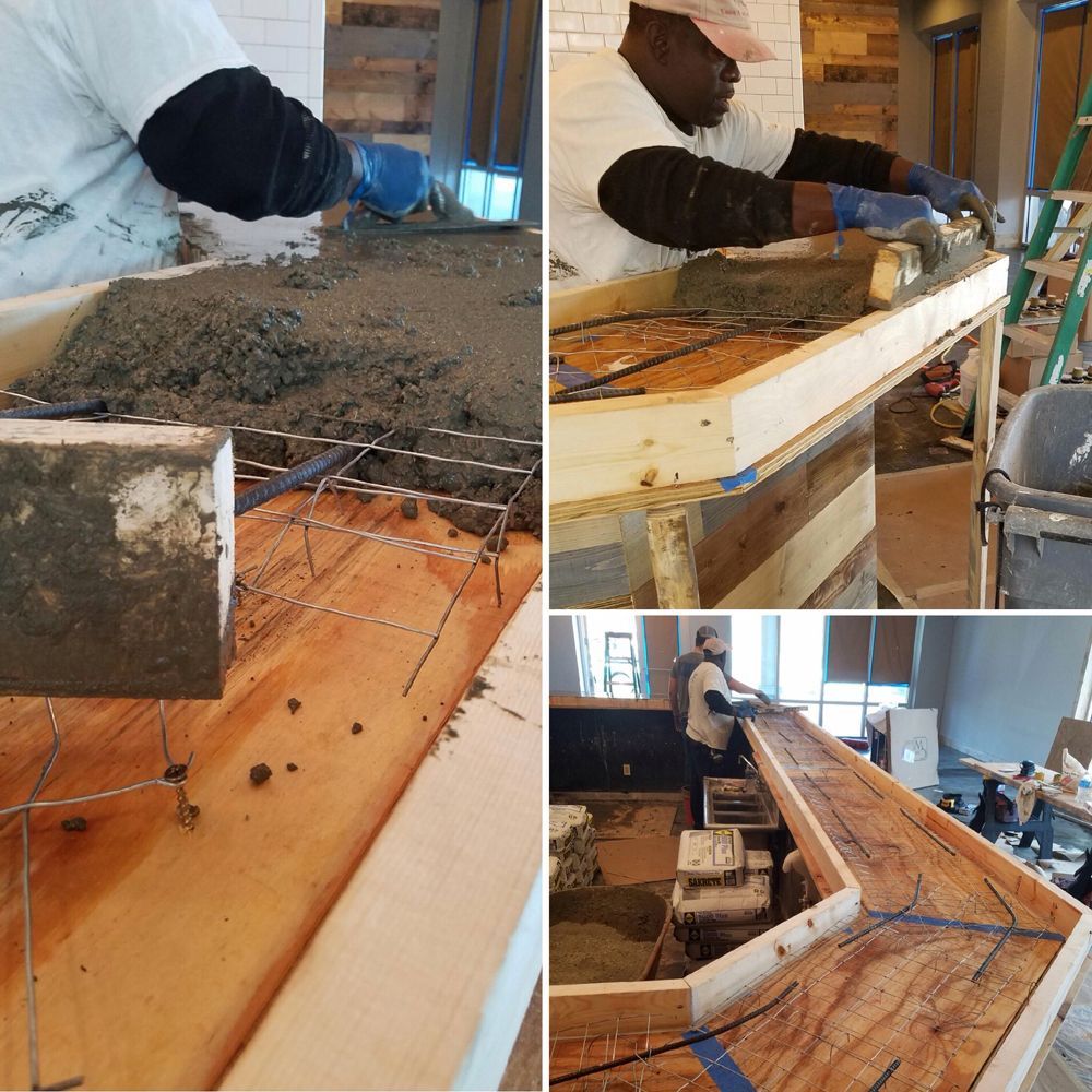 Workers pouring concrete into a wooden mold to create a bar. Construction scene with tools and supplies visible.