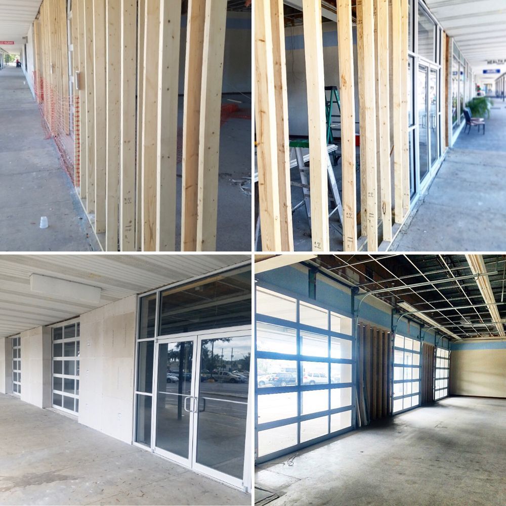 Construction of a storefront, showing framing, walls, and a finished space with windows.