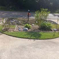 There is a mailbox in the middle of the driveway.