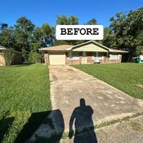 A before picture of a house with a shadow of a person on the sidewalk.