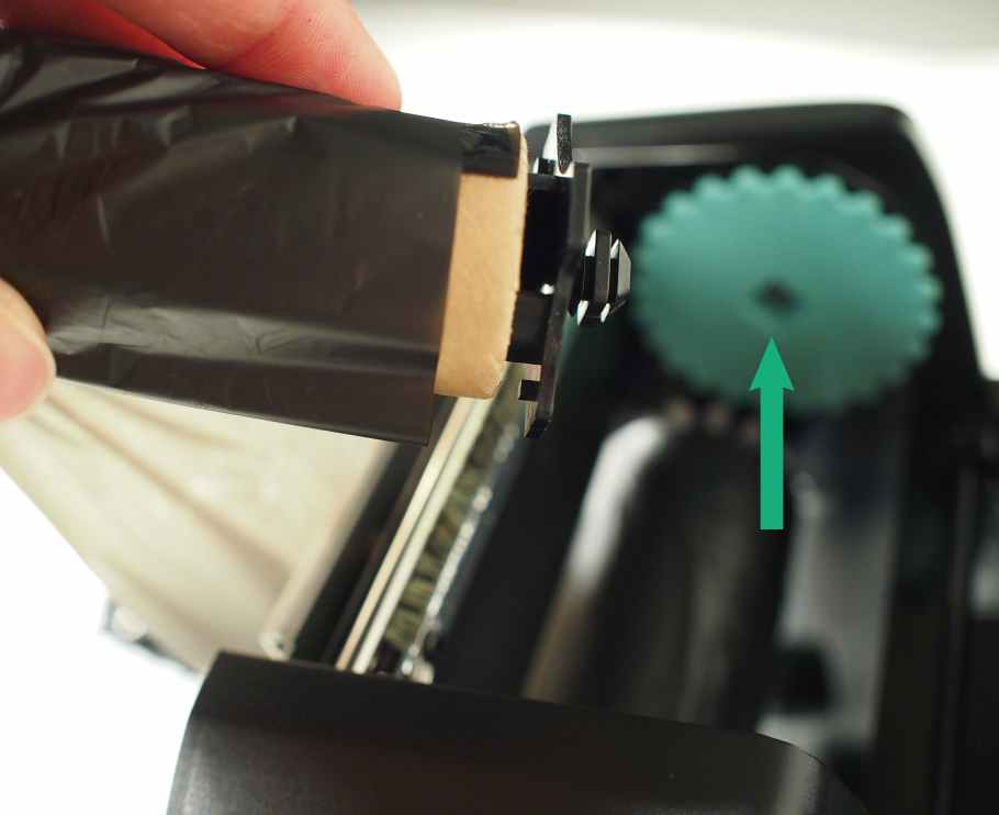 Install the dispense core on the green gear inside the printer