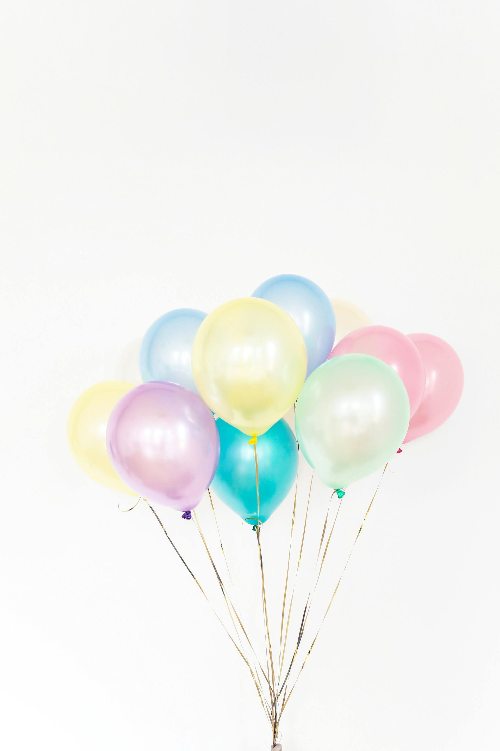 A bunch of colorful balloons on a white background.