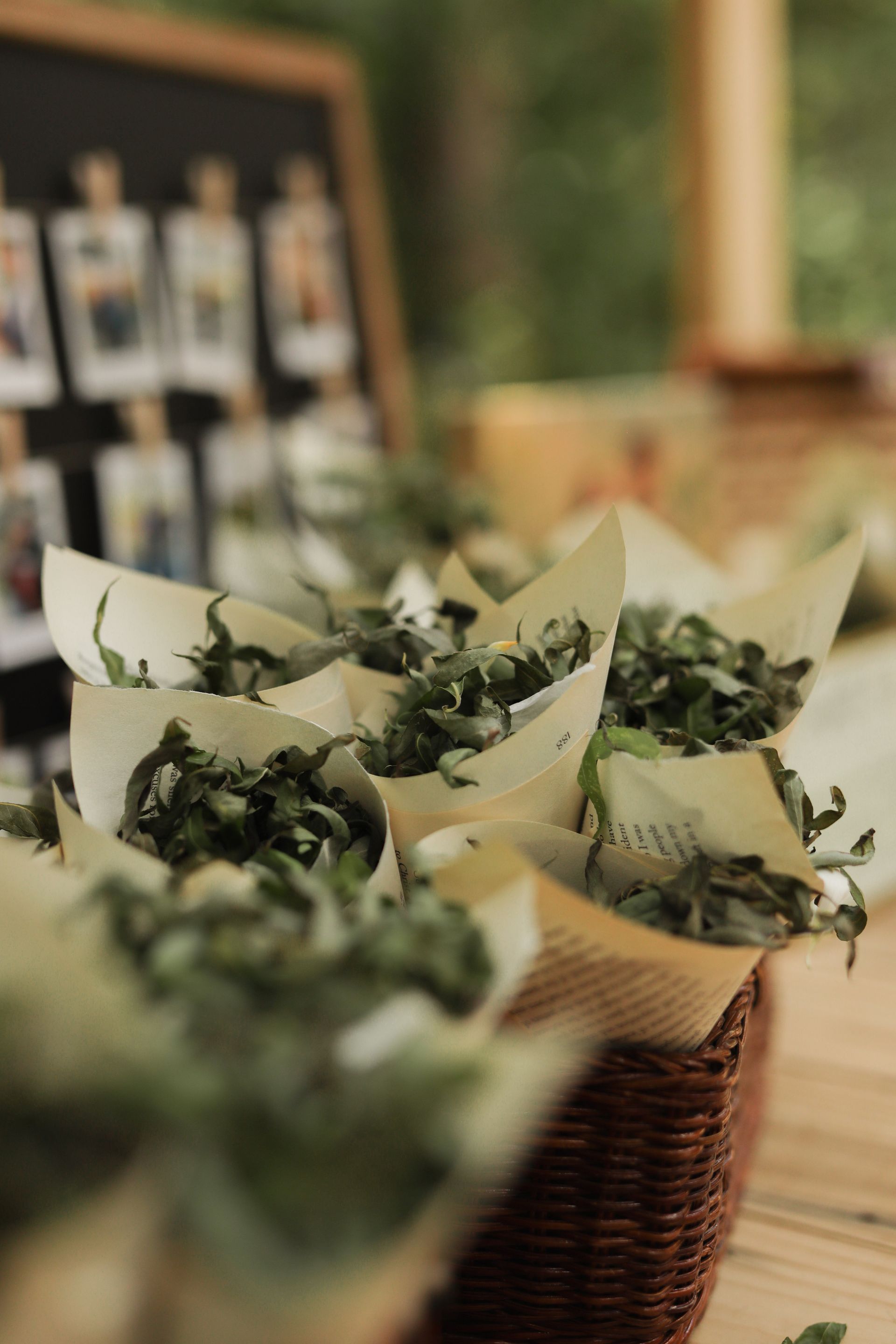 A bunch of cones filled with green leaves are sitting on a wooden table.