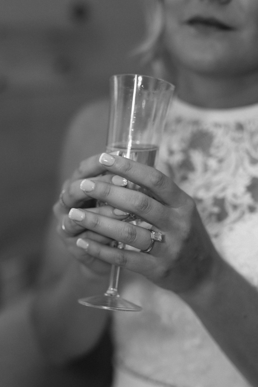 A woman is holding a glass of champagne in her hands.