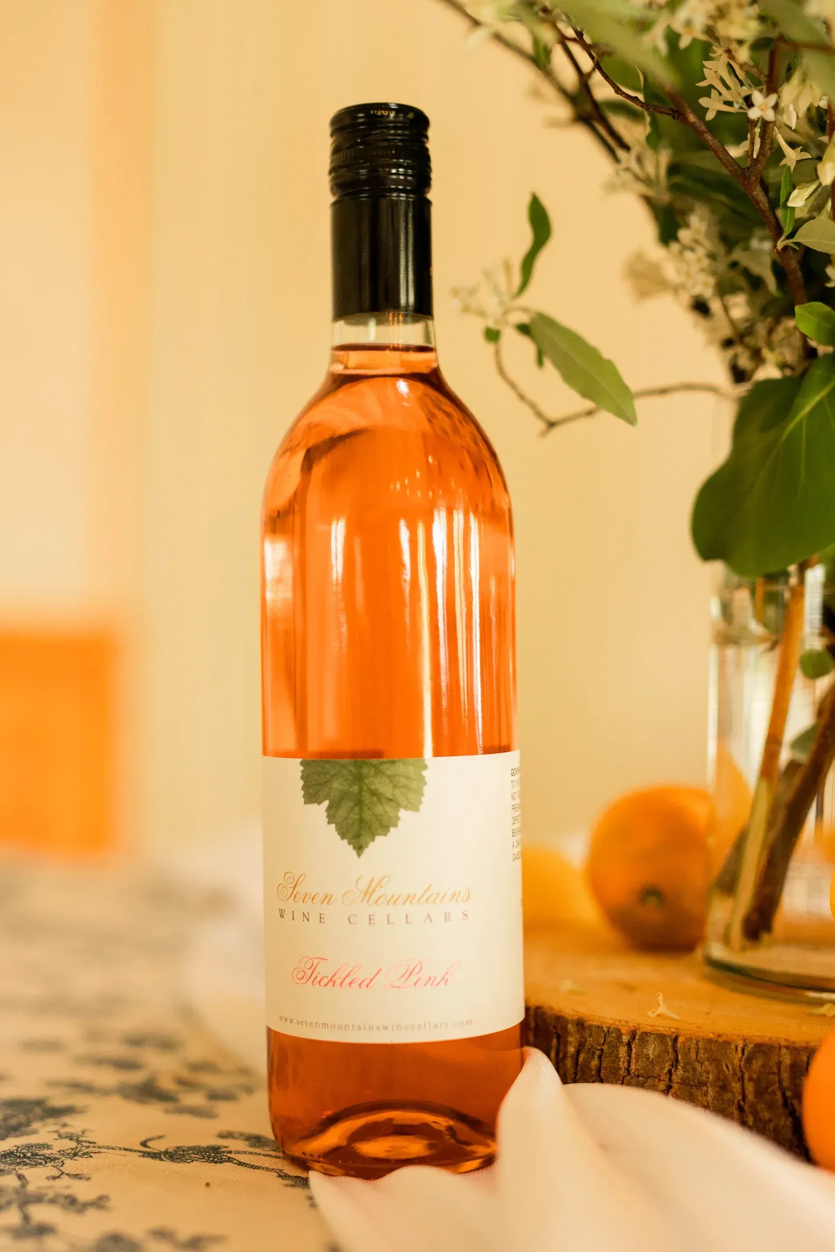 A bottle of rose wine is sitting on a table