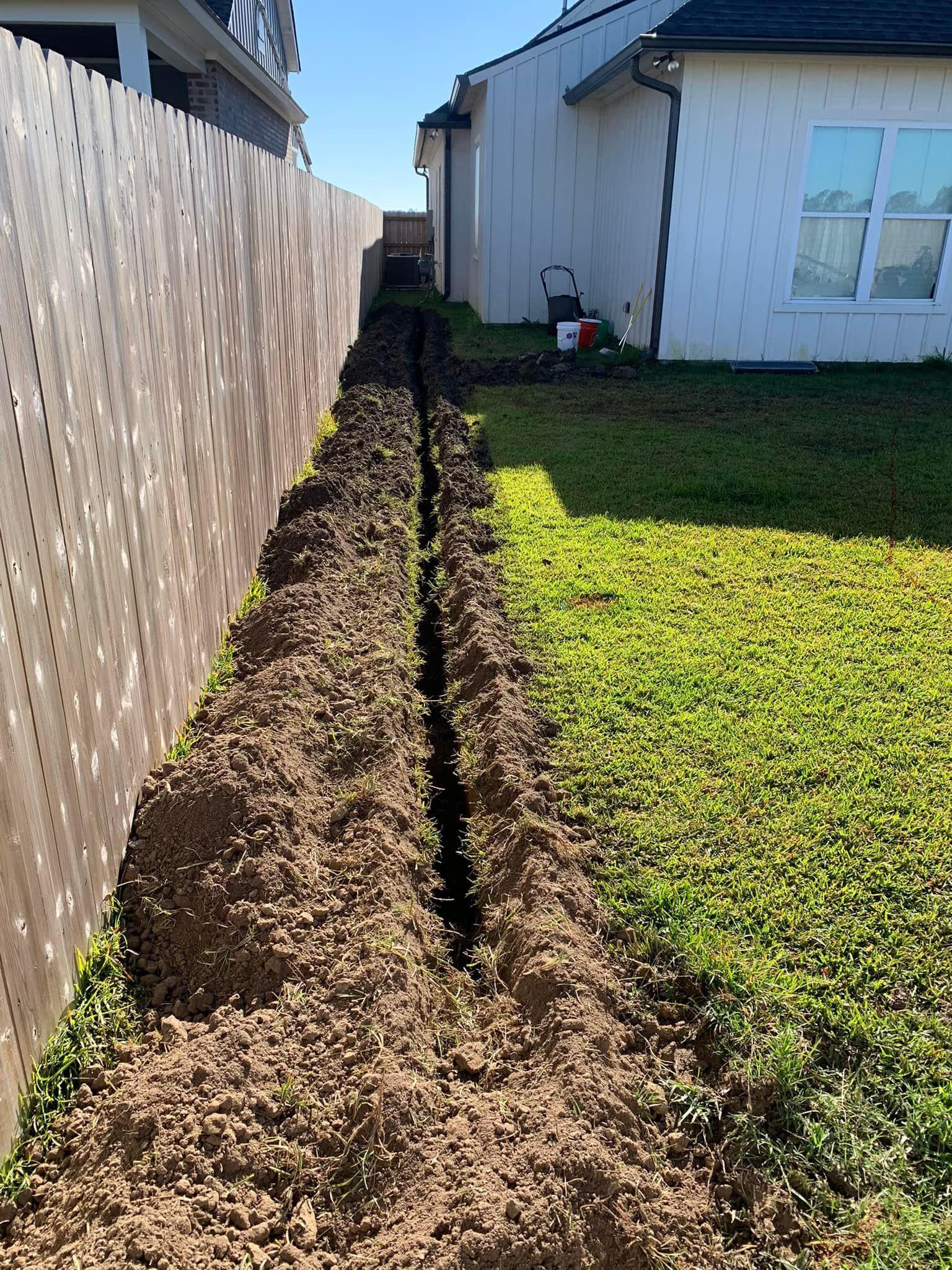 A fence is being built in the backyard of a house.
