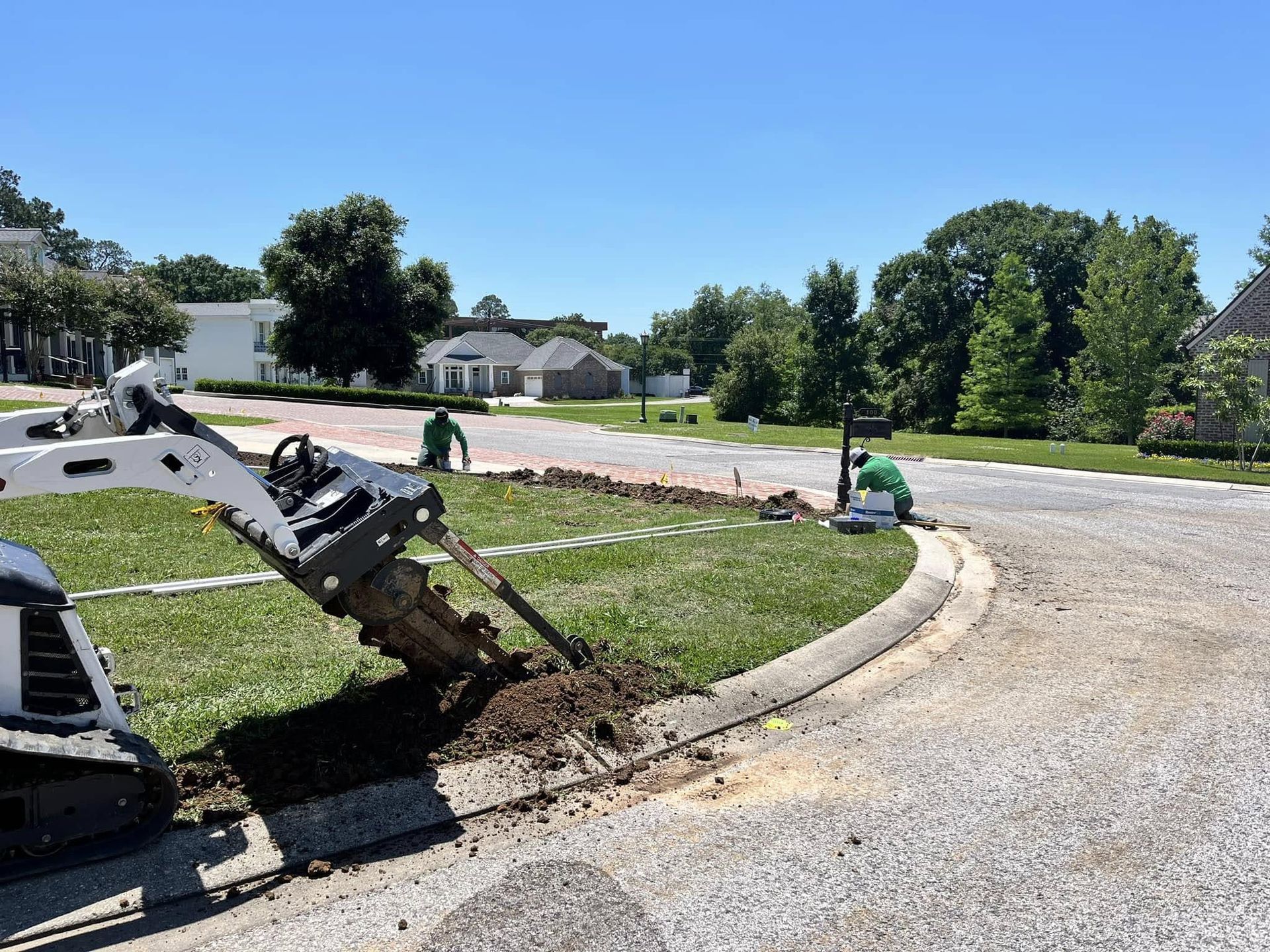 A bulldozer is digging a hole in the side of a road.