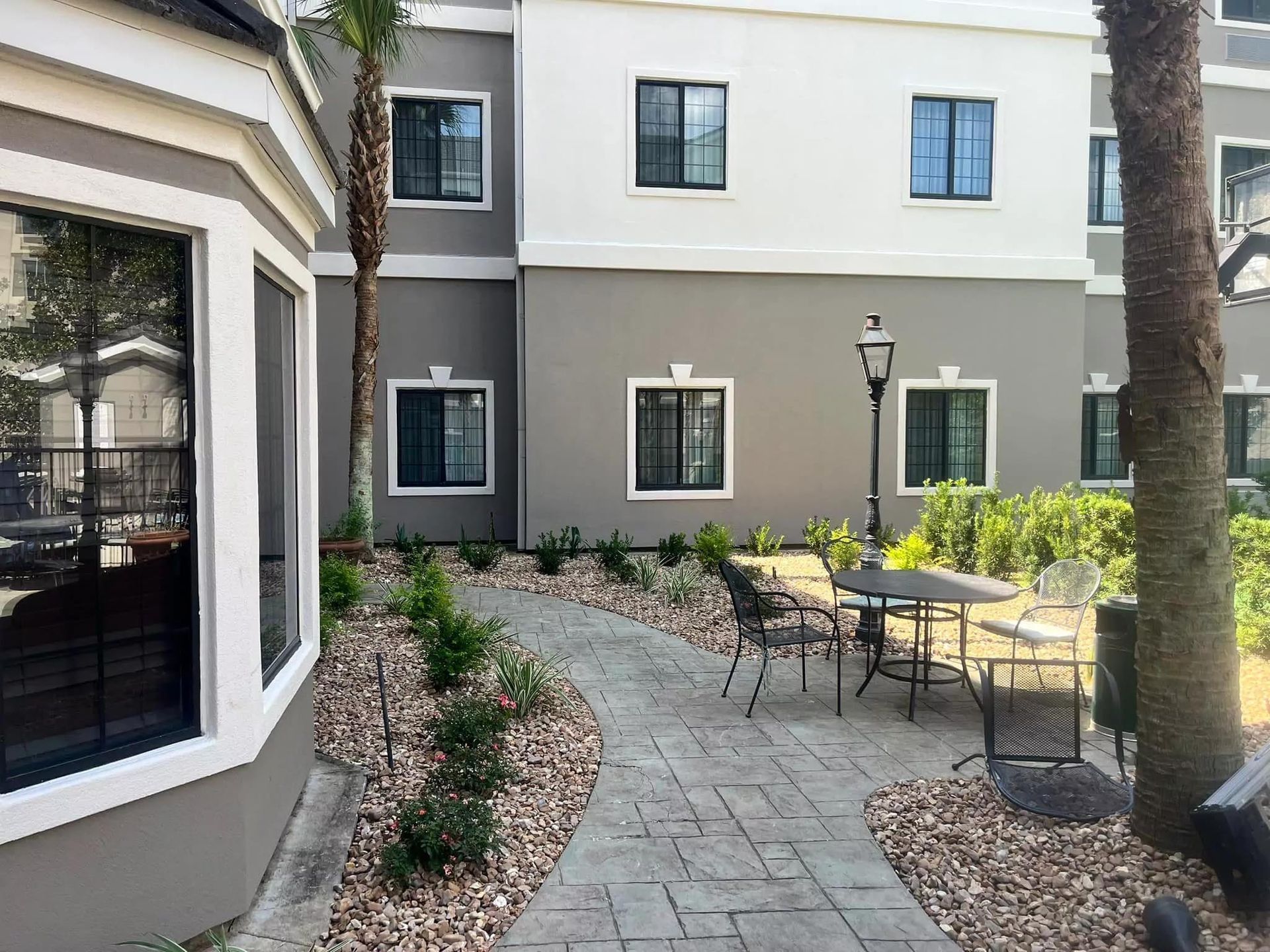 A courtyard with tables and chairs in front of a building