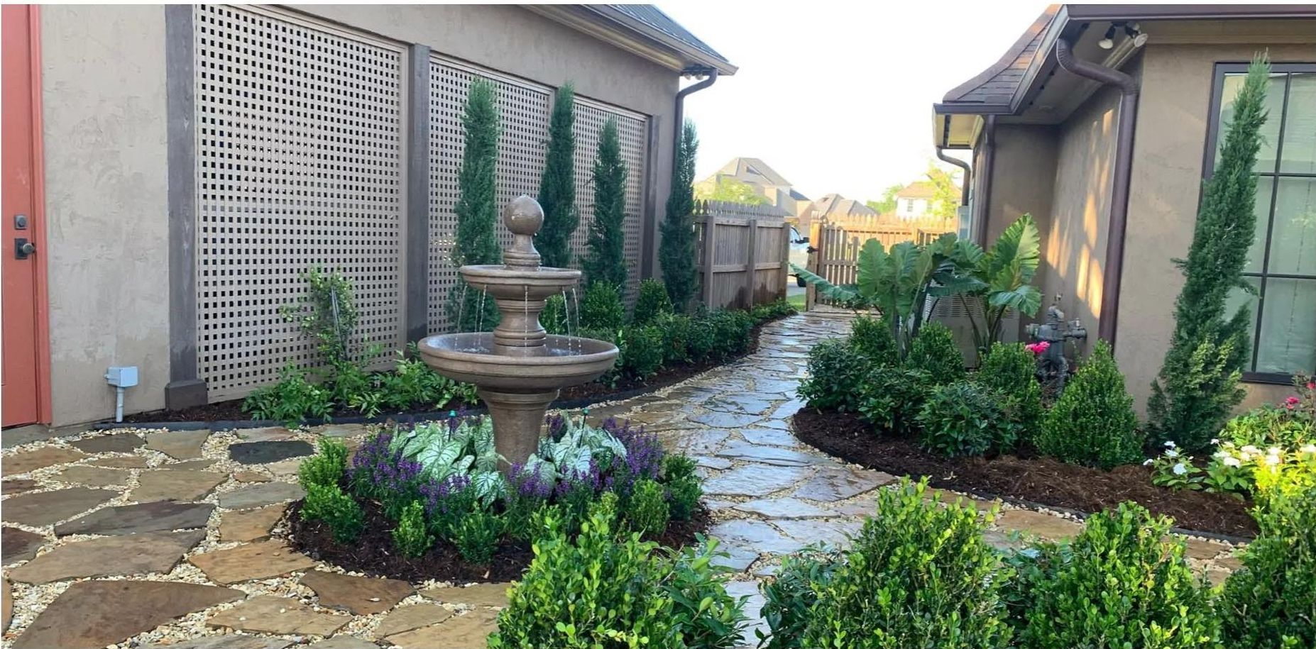 A stone walkway with a fountain in the middle