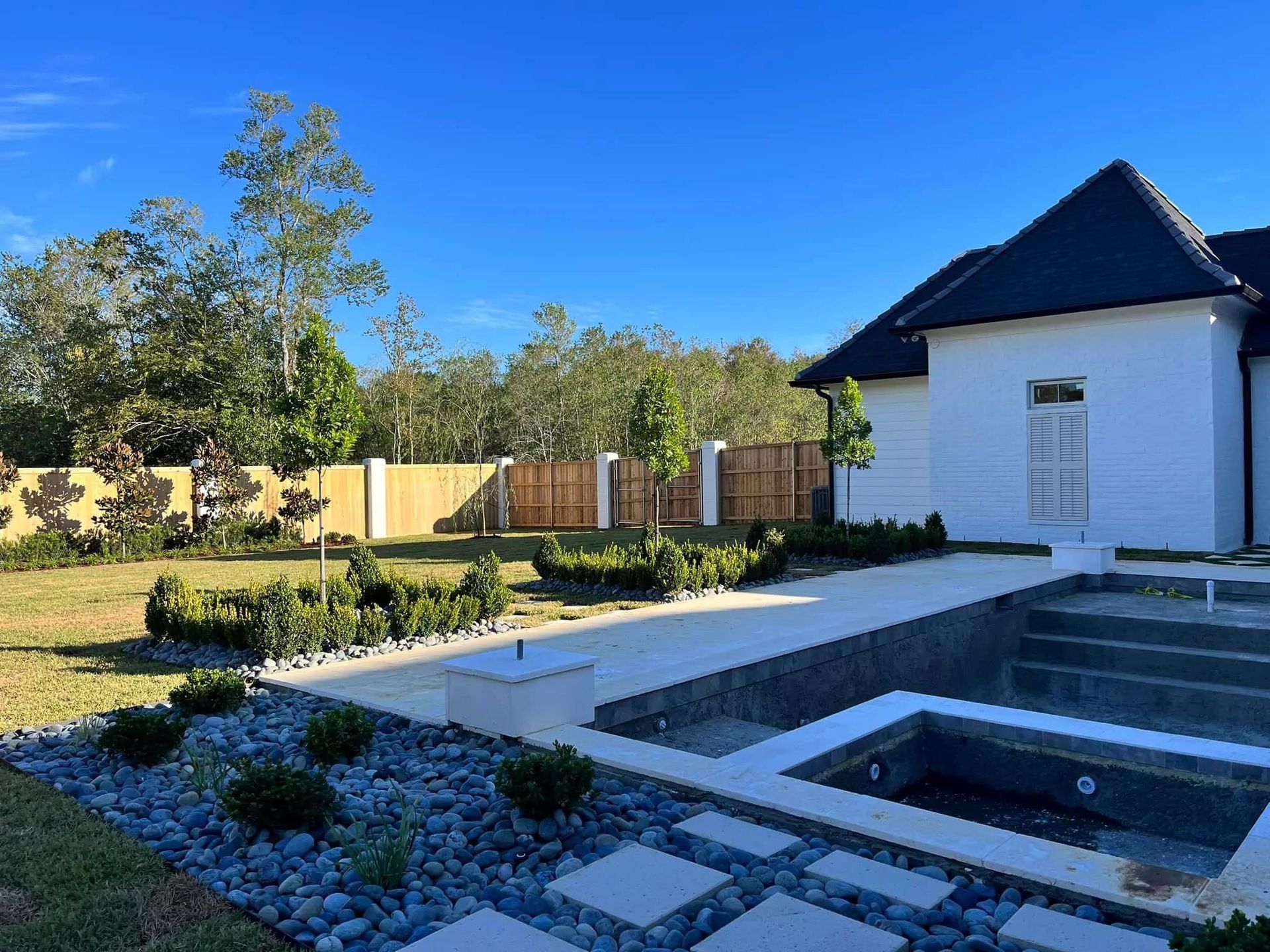 A large white house with a swimming pool in the backyard.