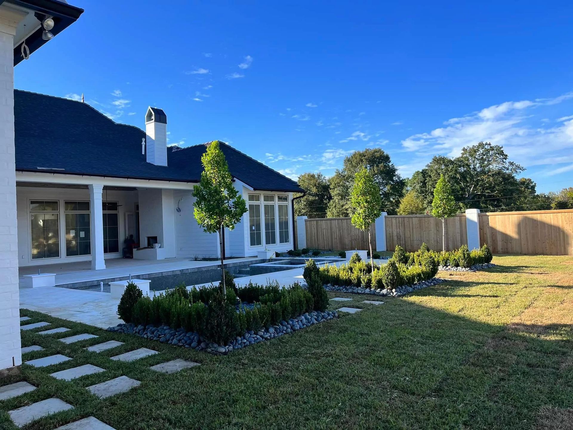 A large white house with a large lawn in front of it.