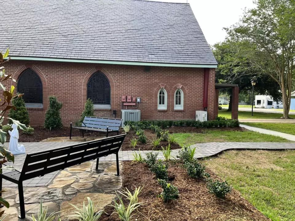 A brick building with a bench in front of it.