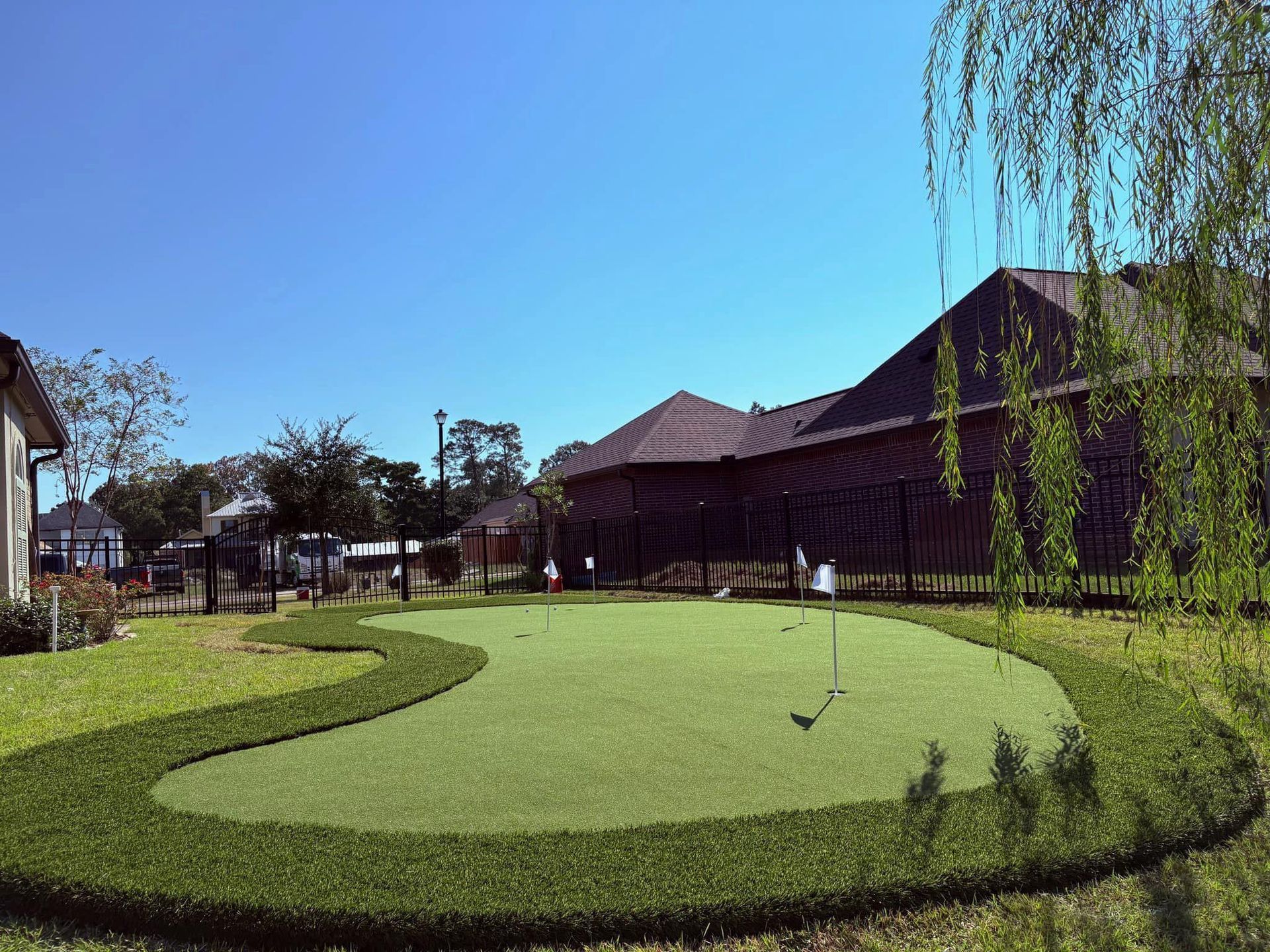 A putting green in the backyard of a house