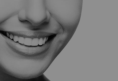 It is a black and white photo of a woman 's smile.