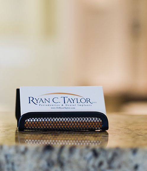 A business card for ryan c. taylor is sitting on a counter