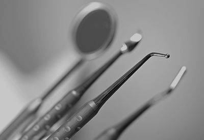 A black and white photo of dental instruments on a table.