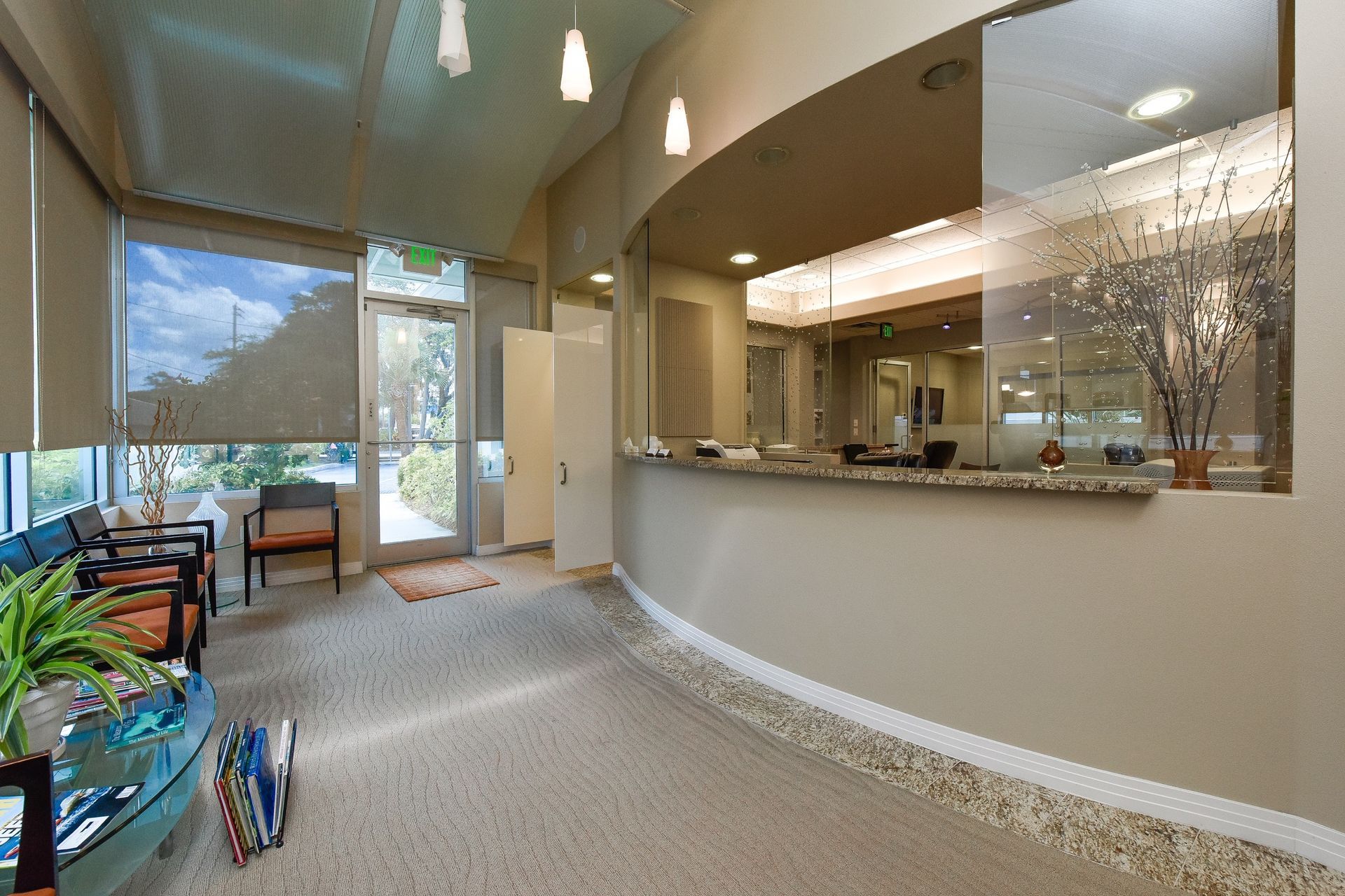 A waiting room with chairs and a counter in a dental office