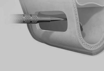 A black and white photo of a needle sticking out of a plastic container.