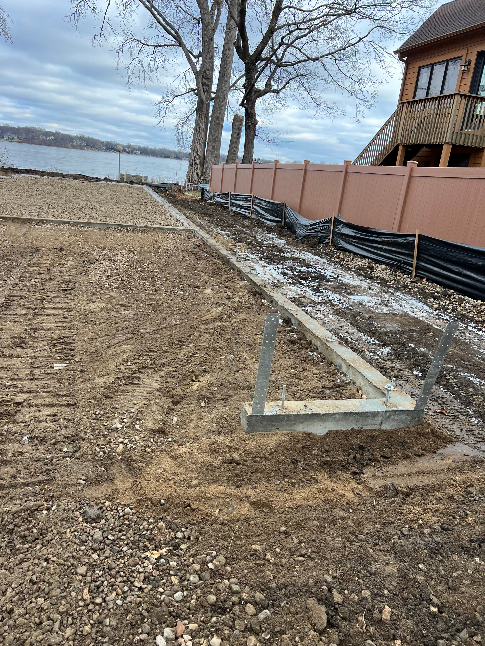 A fence is being built next to a body of water.