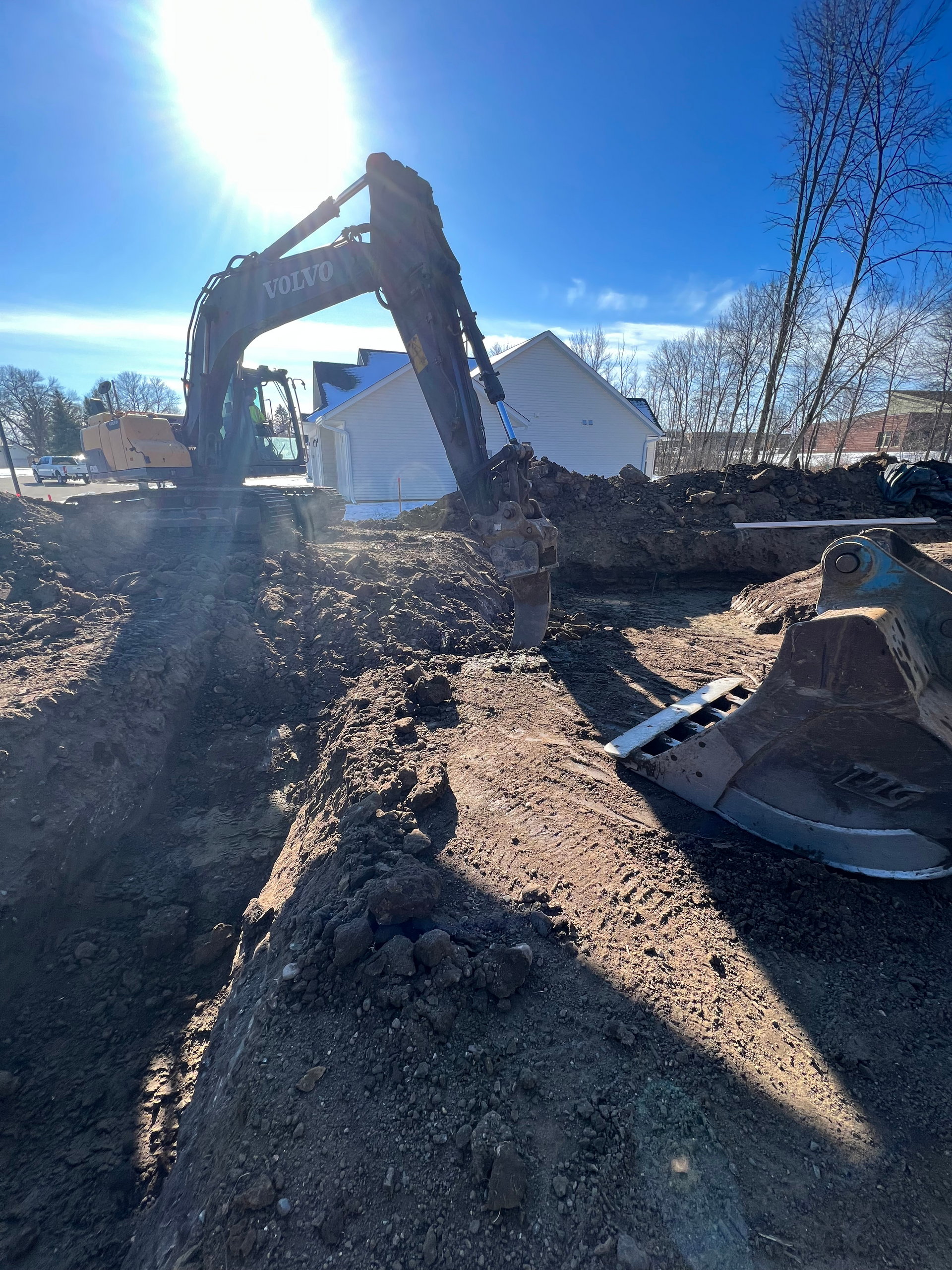 A large excavator is digging a hole in the ground.