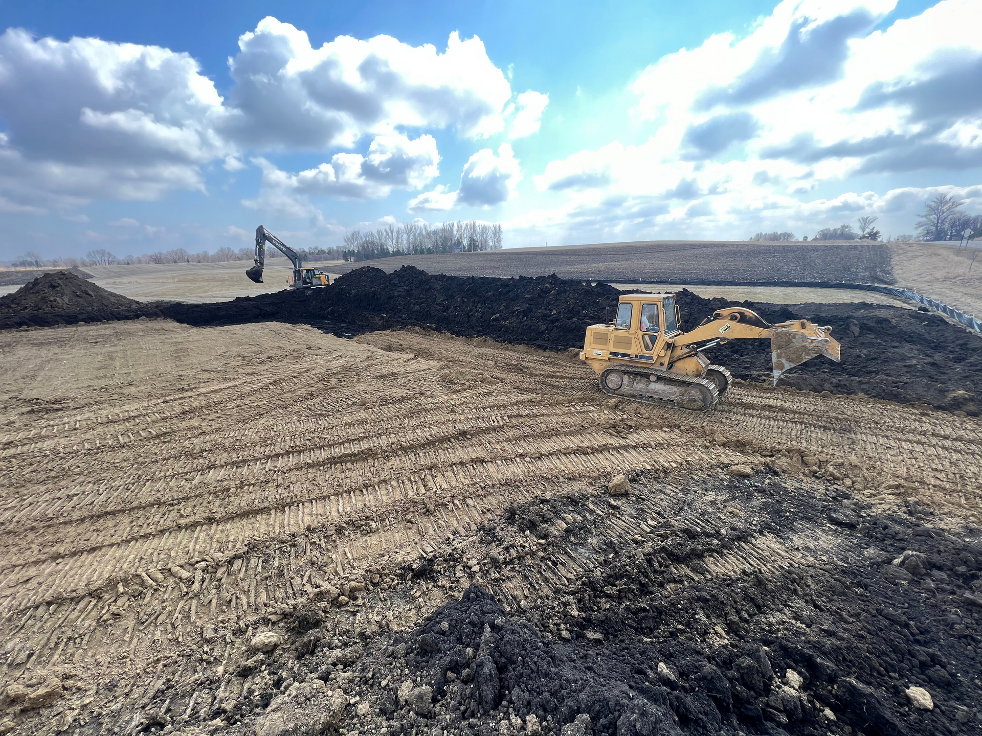 A bulldozer is moving dirt in a field.