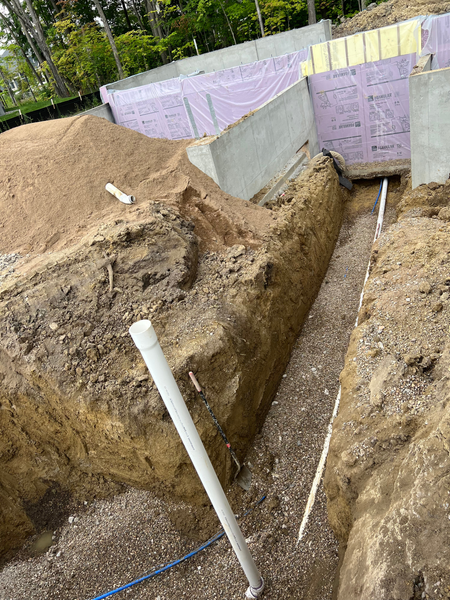 A large hole in the ground with a pipe in it.