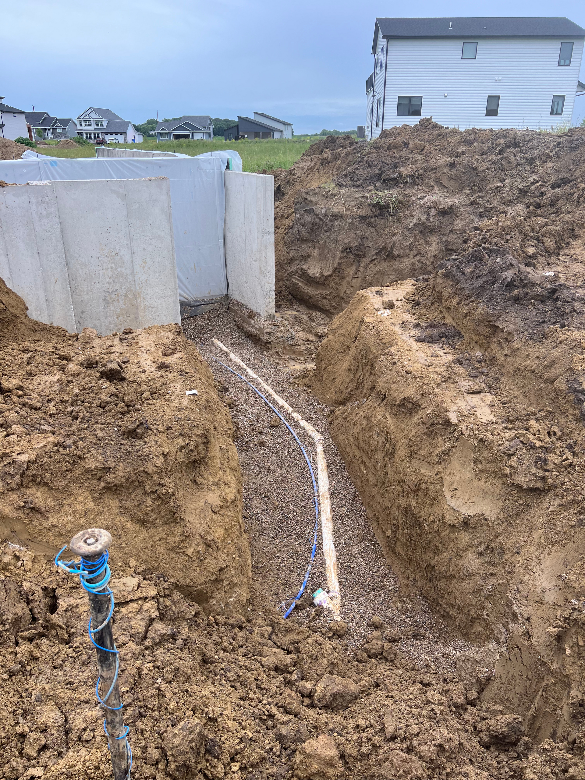 A large pile of dirt is sitting in front of a house.
