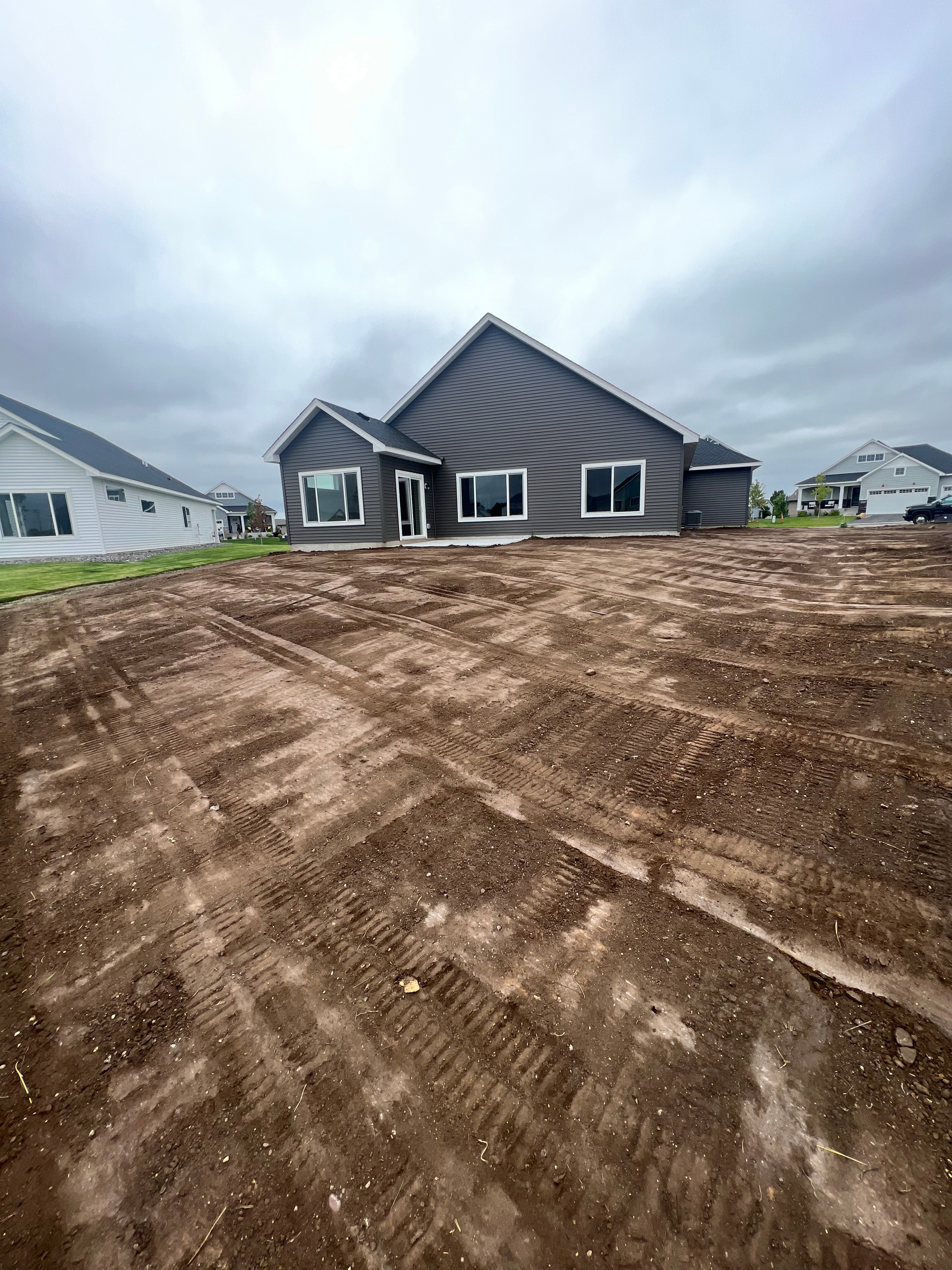 A house is being built on a dirt lot.