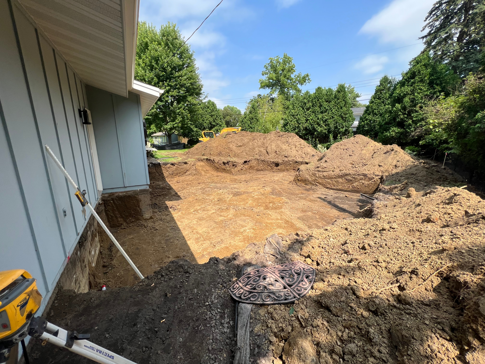 A large pile of dirt is sitting in front of a house.